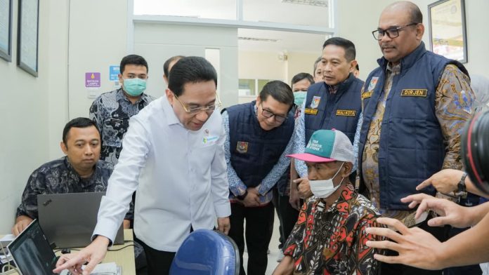 Malang – Direktur Jenderal Bina Administrasi Kewilayahan Kementerian Dalam Negeri (Kemendagri), Safrizal ZA, menegaskan bahwa percepatan eliminasi tuberkulosis (TBC) membutuhkan kepemimpinan kepala daerah yang kuat serta kolaborasi lintas sektor hingga ke tingkat desa dan kelurahan. Menurutnya, TBC bukan semata persoalan kesehatan, melainkan isu pembangunan yang memerlukan keterlibatan seluruh pemangku kepentingan. Hal tersebut disampaikan Safrizal saat membuka Rapat Koordinasi Fasilitasi Teknis Intervensi Kewilayahan dalam Penanggulangan Tuberkulosis yang dirangkaikan dengan Rakorpusda Penguatan Komitmen dan Aksi Nyata Percepatan Penanggulangan Tuberkulosis Berkelanjutan di Malang, Kamis (30/7). Sebelum rapat dimulai, Safrizal bersama Wakil Menteri Kesehatan RI dr. Benyamin Paulus Octavianus, Sp.P., FISR, dan Wali Kota Malang Wahyu Hidayat serta jajaran kementerian, pemerintah daerah, dan para peserta melakukan kunjungan lapangan ke Puskesmas Cisadea, Kota Malang. Kunjungan tersebut dilakukan untuk melihat secara langsung implementasi penanganan TBC di Kota Malang yang dinilai sebagai salah satu daerah dengan kinerja terbaik dalam pengendalian TBC. Berbagai inovasi layanan, mulai dari penemuan kasus secara aktif, pendampingan pasien hingga penguatan jejaring layanan kesehatan, menjadi praktik baik yang diharapkan dapat direplikasi oleh daerah lain. Rapat koordinasi tersebut juga dihadiri Wakil Wali Kota Batu Heli Suyanto, Wakil Bupati Malang Lathifah Shohib, serta pejabat dari Kementerian Dalam Negeri, Kementerian Kesehatan, Kementerian Koordinator Bidang Pembangunan Manusia dan Kebudayaan, Kementerian Sekretariat Negara, pemerintah daerah, hingga camat, lurah, kepala desa, kepala puskesmas, PKK, Posyandu, dan kader TBC dari berbagai daerah di Indonesia. Dalam penyampaiannya, Safrizal mengajak pemerintah daerah memanfaatkan pengalaman berbagai negara yang sukses menekan angka TBC. Menurutnya, tidak ada negara yang berhasil mengendalikan TBC hanya melalui layanan kesehatan. Keberhasilan tersebut lahir dari perpaduan kepemimpinan yang kuat, tata kelola yang efektif, inovasi, pembiayaan yang memadai, serta kolaborasi lintas sektor. Ia mencontohkan sejumlah praktik baik yang dapat diadaptasi Indonesia. Kuwait dan Arab Saudi memperkuat pencegahan melalui pengelolaan mobilitas penduduk, Tiongkok dan Myanmar mengembangkan penemuan kasus aktif berbasis komunitas, Ethiopia memperkuat layanan kesehatan primer hingga tingkat desa, sementara Taiwan dan Qatar memanfaatkan digitalisasi untuk meningkatkan kepatuhan pengobatan. Di sisi lain, India, Brasil, dan Afrika Selatan mengintegrasikan perlindungan sosial dengan inovasi medis dalam pengendalian TBC. Safrizal juga membagikan pengalamannya saat menjabat sebagai Wakil Ketua Satuan Tugas Penanganan COVID-19 Nasional. Menurutnya, keberhasilan Indonesia mengendalikan pandemi menjadi bukti bahwa tantangan besar dapat diatasi melalui kepemimpinan yang kuat, koordinasi lintas kementerian dan lembaga, serta partisipasi aktif masyarakat. “Pengalaman penanganan COVID-19 membuktikan bahwa ketika seluruh unsur pemerintah bergerak dalam satu komando, didukung kolaborasi lintas sektor dan partisipasi masyarakat, tantangan sebesar apa pun dapat dihadapi bersama. Semangat kolaborasi yang sama harus kita hadirkan dalam percepatan penanggulangan TBC,” ujar Safrizal. Mengakhiri sambutannya, Safrizal meminta seluruh gubernur, bupati, dan wali kota memimpin langsung upaya percepatan penanggulangan TBC di wilayah masing-masing. “Saya minta agar para Gubernur, Bupati, dan Walikota untuk memimpin langsung kolaborasi lintas sektor ini di wilayah masing-masing. Pemerintah daerah harus memastikan terbentuk dan berfungsinya Wadah Kemitraan Penanggulangan TBC atau Tim Percepatan Penanggulangan TBC (TP2TBC) yang melibatkan seluruh pemangku kepentingan,” tegas pria yang pernah menjabat sebagai Pj Gubernur Aceh ini. Safrizal menambahkan, keberhasilan eliminasi TBC akan sangat ditentukan oleh kemampuan pemerintah daerah mengintegrasikan program lintas perangkat daerah, dunia usaha, akademisi, organisasi masyarakat, dan komunitas. Dengan sinergi tersebut, target eliminasi TBC nasional diyakini dapat dicapai secara lebih cepat dan berkelanjutan.